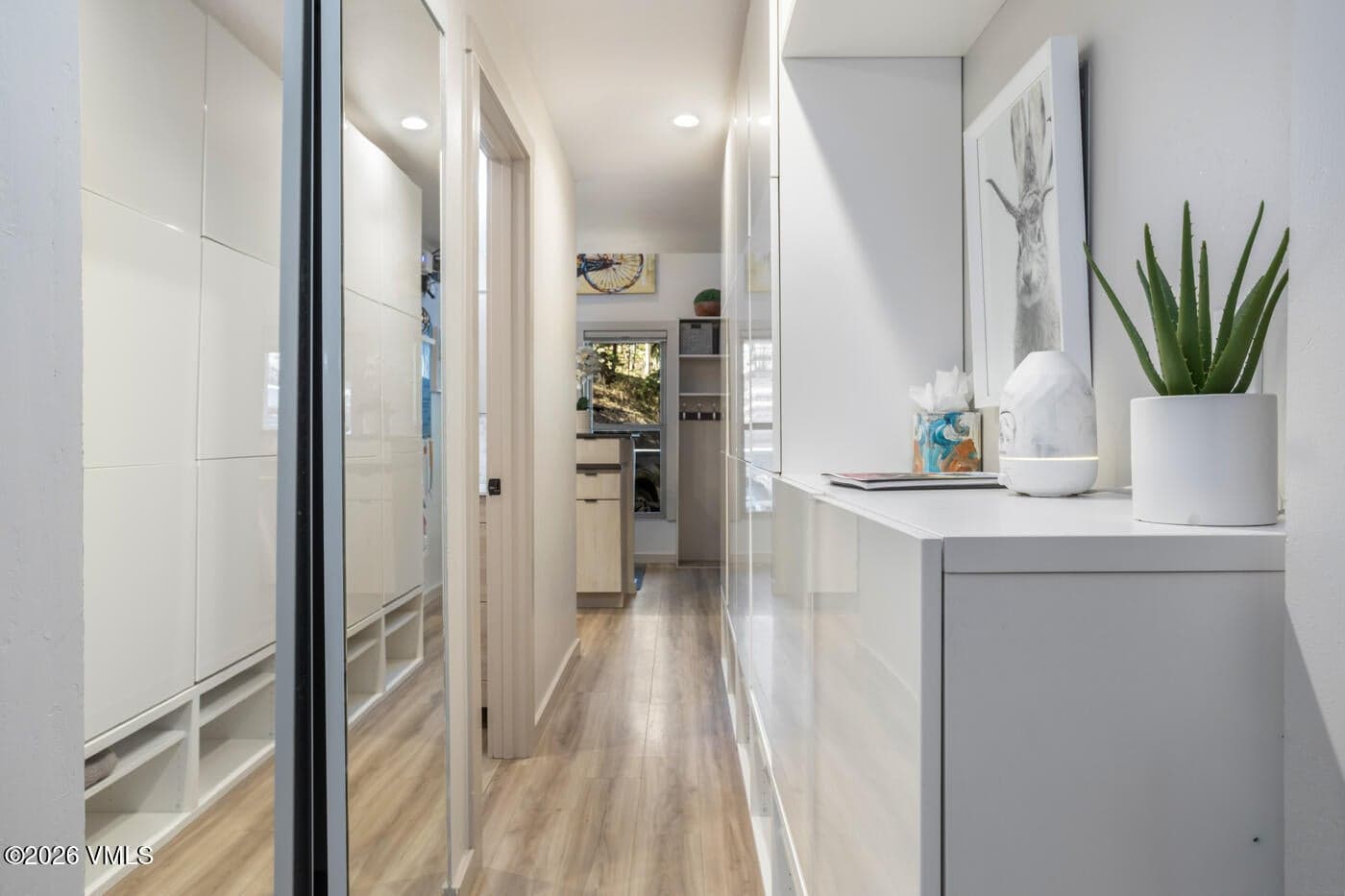 hallway with builtin-closets behind the mirrors