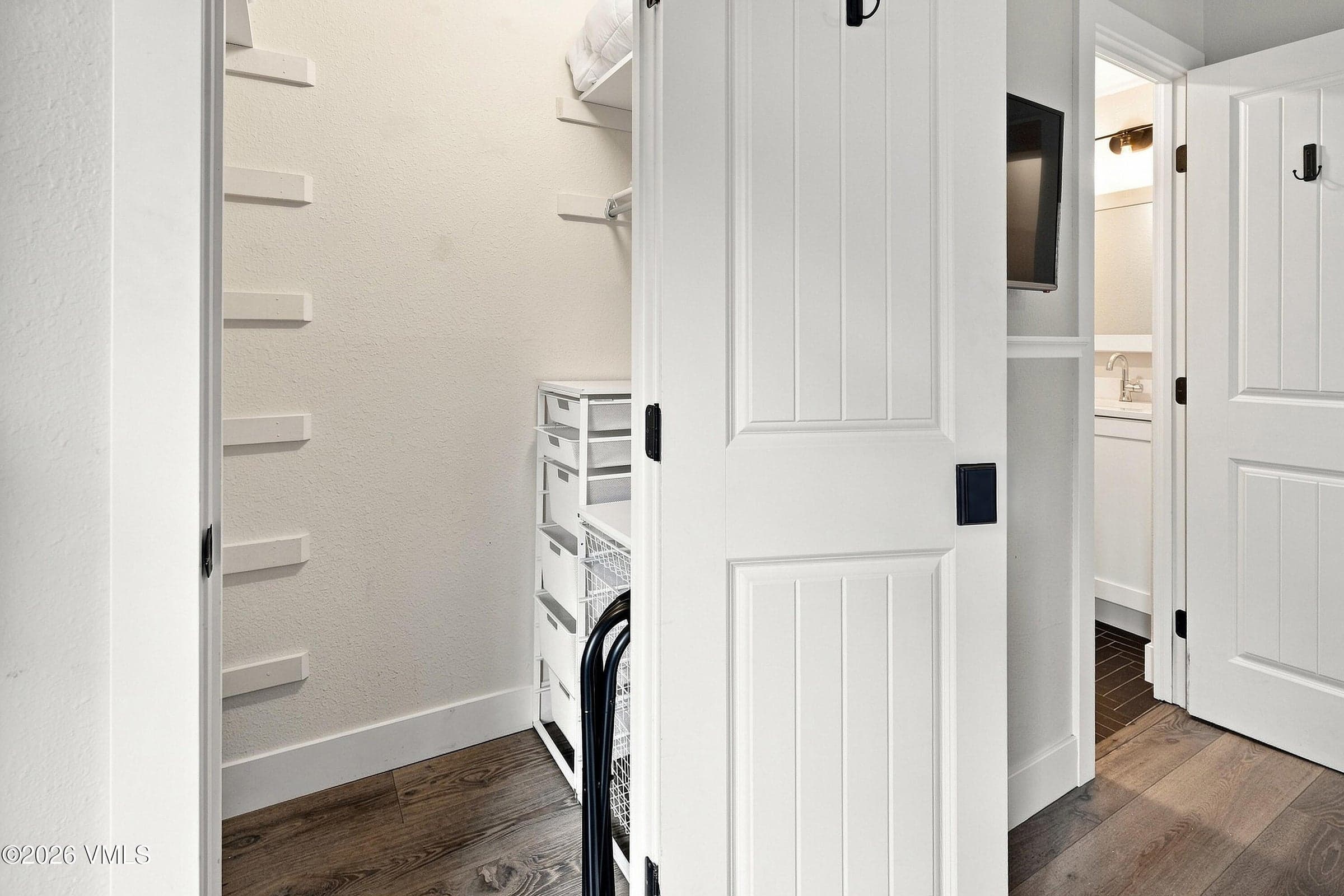 Walk-in closet with built-in shelving and storage.