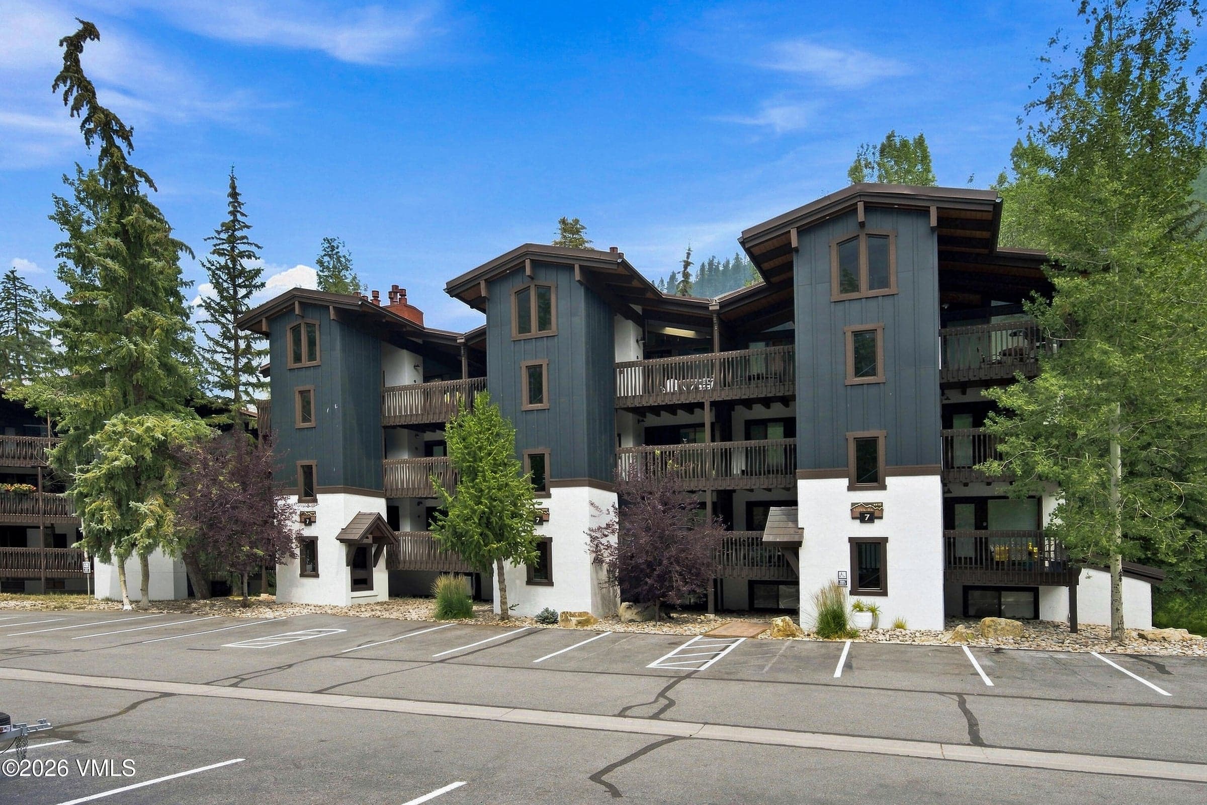 Angled exterior of Building 7 with dedicated parking area.