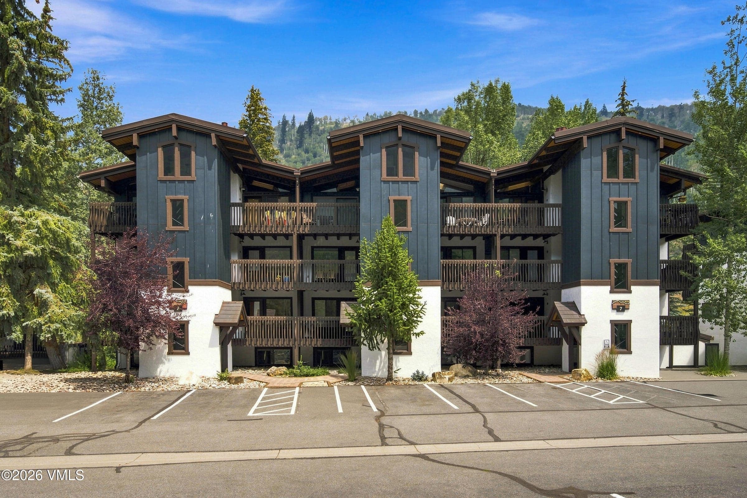 Front exterior of Building 7, mountain-modern architecture with stucco and wood siding.