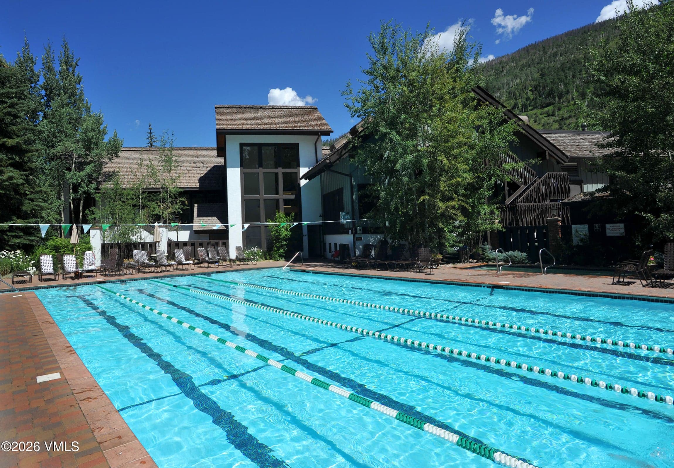 Community lap pool and clubhouse, summer view.
